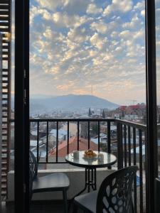 a view from a balcony with a table and chairs at Avlabari Inn - The coziest place in Tbilisi City