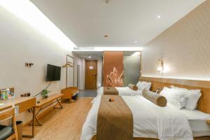 a large hotel room with a large bed and a desk at James Joyce Coffetel Hefei High-speed Railway South Station Branch in Hefei