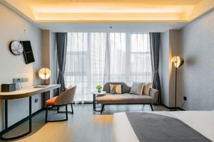 a hotel room with a bed and a couch and a desk at Yitel Xi'an Hi-tech Zone Wanda Plaza in Xi'an +80 photos