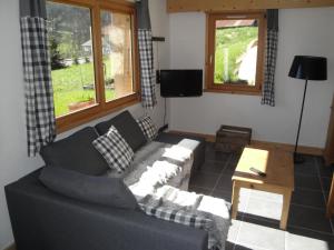 a living room with a couch and a table at Appartement des Crêtets in Megève