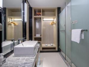 a bathroom with a tub and a sink and a shower at Echarm Hotel Nanning the MixC Exhibition Center Metro Station in Nanning +270 photos