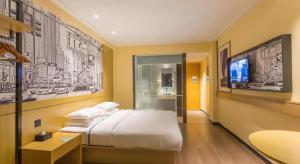 a hotel room with a bed and a tv at City Comfort Inn Nanning Jianzheng Road Food Street in Nanning