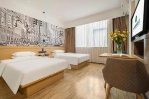 a hotel room with two beds and a tv at City Comfort Inn Nanning Jiangnan Wanda Plaza in Nanning +193 photos