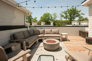 un patio con sofá, mesa y sillas en Creative Oasis Minutes to Broadway Rooftop Deck, en Nashville