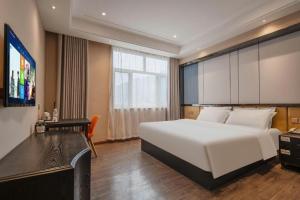 TV a/nebo společenská místnost v ubytování PAI Hotels Shijiazhuang Zhengding Gucheng
