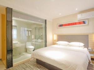 a bedroom with a large bed and a bathroom at City Comfort Inn Hefei Binhu Wanda Plaza in Hefei +185 photos