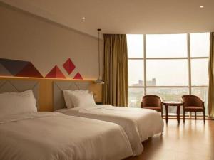 a hotel room with two beds and a window at Borrman Hotel Dongguan Zhongtang in Dongguan +225 photos
