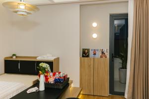 a bedroom with a bed and a table with snacks at Be Staycation Sai Gon in Ho Chi Minh City