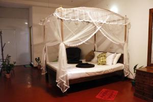 En eller flere senge i et værelse på Tamasha Mango Home stay