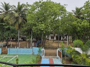 a tennis court in a park with trees at Coastal Heaven Villa in Trincomalee