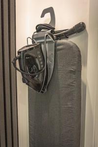 a camera is hanging on the side of a bed at OYO Bellevue Apartments Middlesborough in Middlesbrough