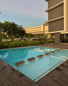 a large swimming pool in front of a building at Millennial Minimalist haven in Durban