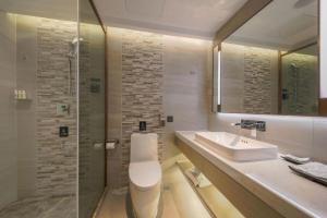 a bathroom with a toilet and a sink and a shower at Lavande Hotel Wuhan Jianghan Road Dunli Gate Metro Station in Wuhan +59 photos