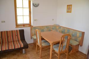 a table and chairs and a couch in a room at Apartma Marjetica 47 in Moravske-Toplice
