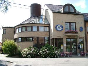 a building with a clock on the side of it at Alsput Hotel in Halle