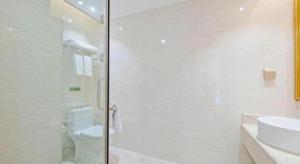 a bathroom with a shower and a toilet and a sink at Vienna Hotel Guangdong Zhongshan Ancient Town Haizhou in Zhongshan +45 photos