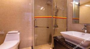 a bathroom with a shower and a toilet and a sink at Super 8 Hotel Guiyang Qianling Park Ruijin North Road in Guiyang