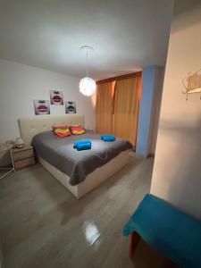 A bed or beds in a room at First Line Beach Apartment with Ocean View La Arena