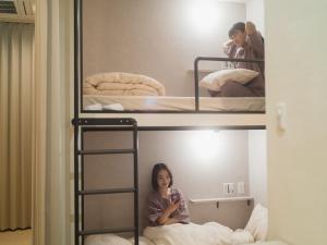 Postel nebo postele na pokoji v ubytování HOTEL minimumms女性専用カプセルホテルWomen only hotel
