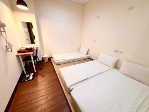 Ένα ή περισσότερα κρεβάτια σε δωμάτιο στο Douzi Hotel-Xpark. Gloria Outlets. Taoyuan MRT