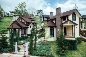 a large house with a landscaping in front of it at The Bluesky Resort @ Khao Kho in Campson