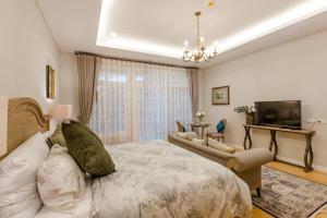 a bedroom with a large bed and a television at The Bluesky Resort @ Khao Kho in Campson