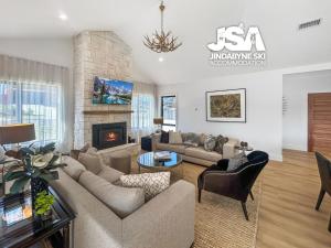 a living room with a couch and a fireplace at Allenvale in Jindabyne