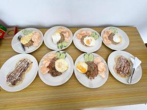 a group of plates of food on a table at Mutiara Danu Villa in Kubupenlokan