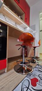 a kitchen with two bar stools on a counter at SWEET & CHILLI Home 28 in Thessaloniki +21 photos