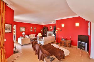 Habitación con paredes rojas y sala de estar. en Villa Çınarlar en Kas
