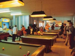 a group of people playing pool in a room at Mobil Home in Saint-Jean-de-Monts