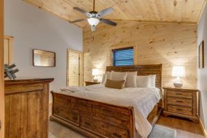 a bedroom with a bed and a ceiling fan at High Johnny's Hideout- Secluded w Private Hot Tub in Sevierville