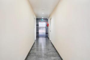 an empty corridor in an office building with a door at Super Hotel O Koramangala Near Sony Signal in Bengaluru