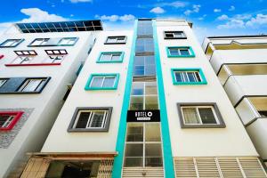 a tall white building with colorful windows at Super Hotel O Koramangala Near Sony Signal in Bengaluru