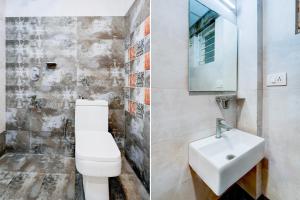 a bathroom with a white toilet and a sink at Super Hotel O Koramangala Near Sony Signal in Bengaluru +20 photos