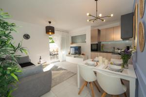 a kitchen and living room with a table and chairs at Pool and Breakfast Apartments Villa Maro in Novalja +107 photos