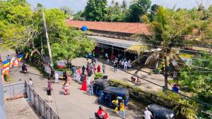a group of people standing outside of a train station at Railway Hostel in Matara