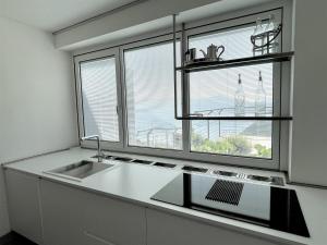 a kitchen with a sink and a window at IseoLakeRental - Dove il Lago Brilla in Vigolo +11 photos