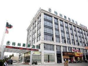 a large building on the corner of a street at GreenTree Inn Shanghai Minhang Development Zone Subway Station Business Hotel in Shanghai