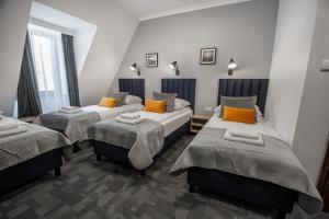 a room with three beds in a room at Soul Rooms Old Town Gdansk in Gdańsk