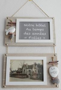 a picture frame with a picture of a house at Hôtel Villa Teranga in Andernos-les-Bains