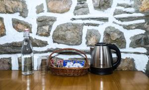a basket of candy and a bottle of water on a table at Sanskritik Homestay in Rāni Pokhri