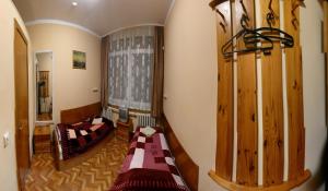 a room with two beds and a couch in it at nakvinės namai Mano kelias in Vilnius
