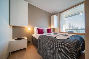 a bedroom with a bed with towels on it at Peak Chalet B6 Ski-in Ski-out by Aavalevi in Levi
