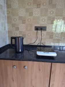 a coffee pot sitting on top of a counter at Cozy Scenic Farmhouse Retreat in Mangalore