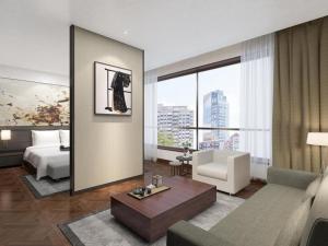 a living room with a couch and a bed in a room at NH Shijiazhuang Financial Center in Shijiazhuang +194 photos
