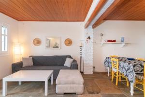 a living room with a couch and a table at Porto Blue Horizon in Agios Ioannis