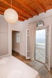 a bedroom with a bed and a view of the ocean at Porto Blue Horizon in Agios Ioannis