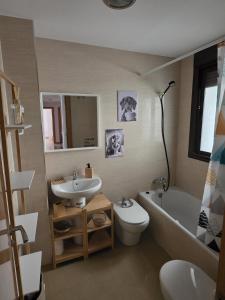 a bathroom with a sink and a toilet and a bath tub at Piso 'Esquina del Molino' in Berja