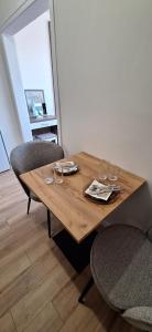a wooden table with two chairs and glasses on it at Mint 1 in Veliko Tŭrnovo